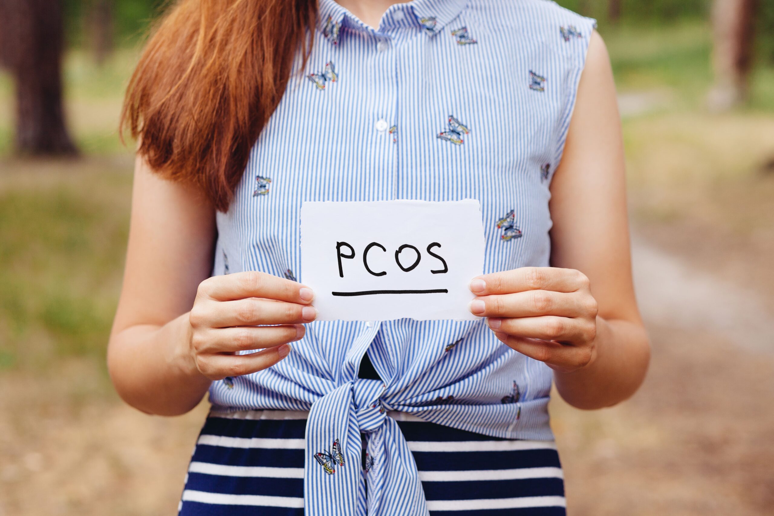 A women holding a PCOS awareness sign