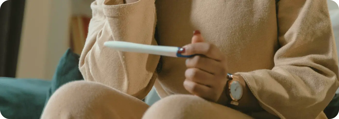 Woman looking at pregnancy test.